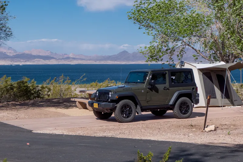 Jeep with a tent attached, parked by Lake Mead at Boulder Beach campground