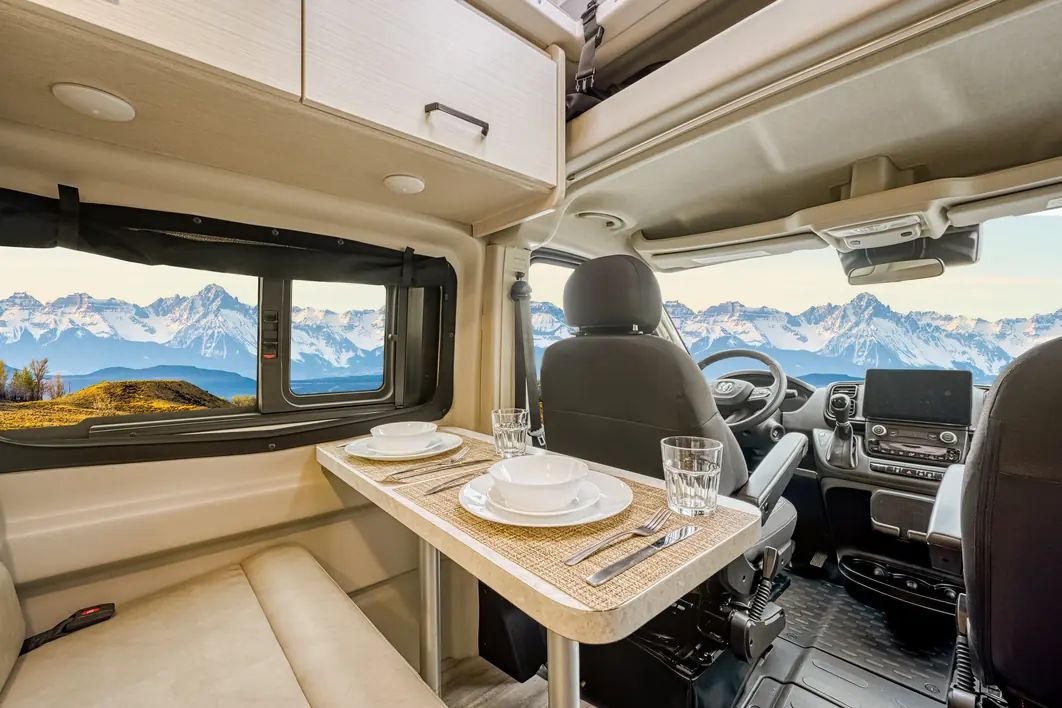 Campervan dinette set for two next to the swivel cab seats