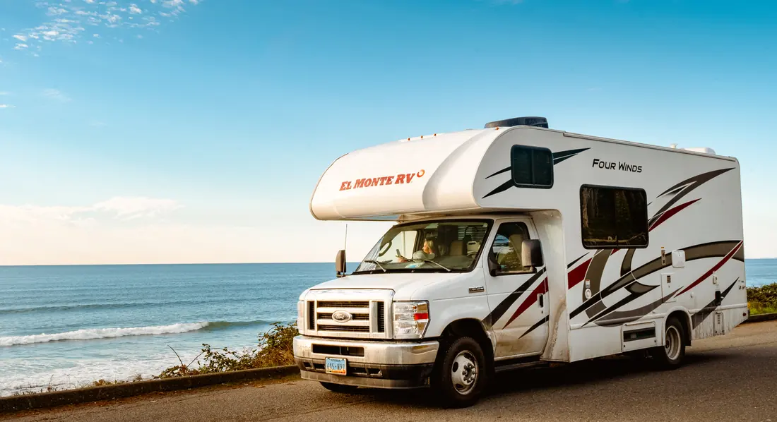 RV on a coastal road above the surf